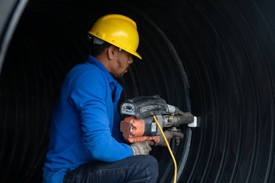 Worker inside large HDPE pipe